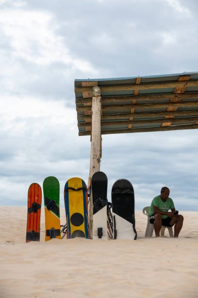 A man rents boards at the sand dunes of Joaquina in Florianópolis, Brazil. The dunes are a popular place for sandboarding. (April 5, 2019)