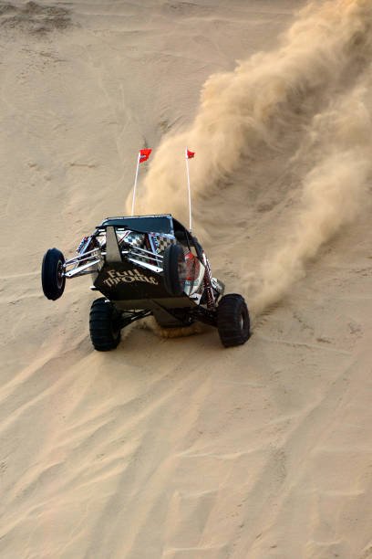 High powered V8 engined Beach Buggies racing with tourists in the afternoon sun in the sand dunes of the Qatari desert, Doha, Qatar.
Qatar is one of the richest countries in the world backed by the world's third-largest natural gas and oil reserves. Qatar offers a wide variety of tourist attractions among others, safari and beach buggy race in the desert