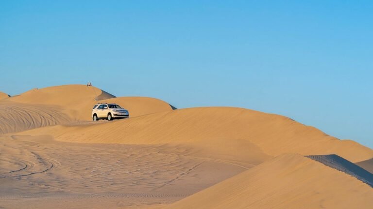 A car driving through the sand dunes in Dubai