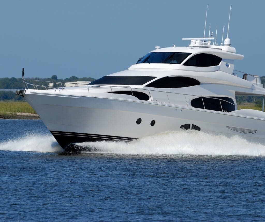 A white motor boat cruising on the water in Dubai.