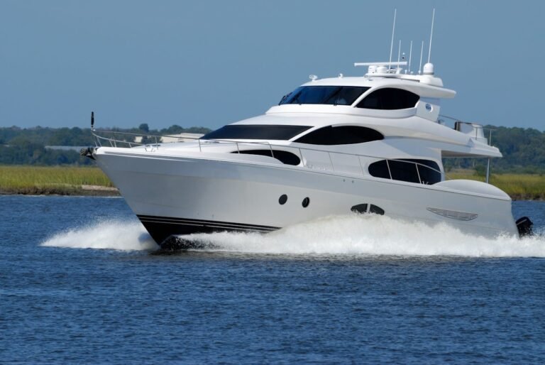 A white motor boat cruising on the water in Dubai.