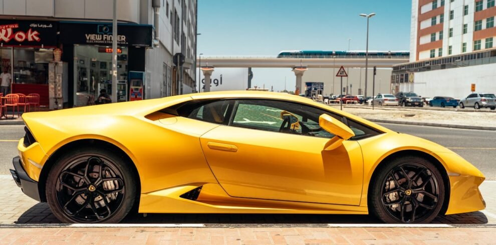 A yellow Lamborghini parked on the side of the road in Dubai.