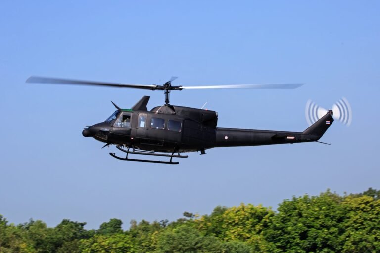 Black helicopter flying above Dubai on an exciting helicopter tour.