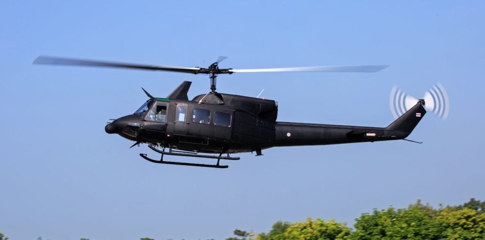 Black helicopter flying above Dubai on an exciting helicopter tour.