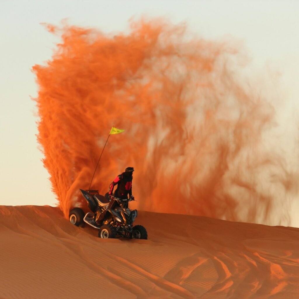 Quad biker navigating a sandy dune on a thrilling Desert Safari excursion.