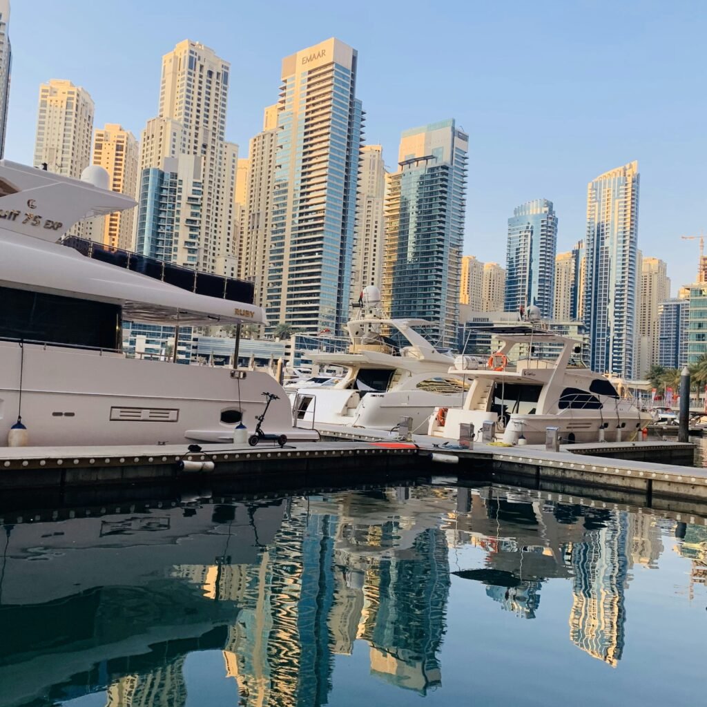 A bustling marina in Dubai with a multitude of boats moored along the waterfront.