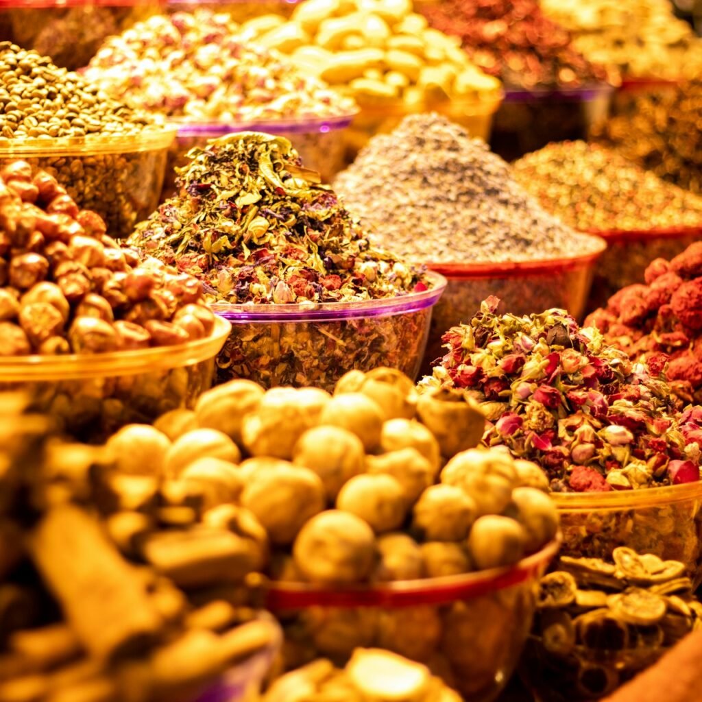 Colorful assortment of spices and nuts in bowls at Dubai's Spice Souk