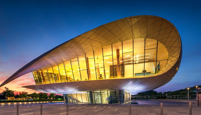 A modern building resembling a wave, showcasing the architectural design of the Etihad Museum in Dubai.