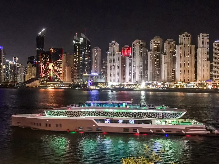 A luxury Lotus Mega yacht cruising on the water with a city skyline in the background.