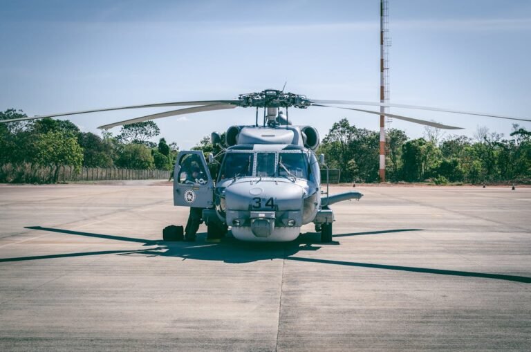 Military helicopter parked on tarmac, part of helicopter tour in Dubai.