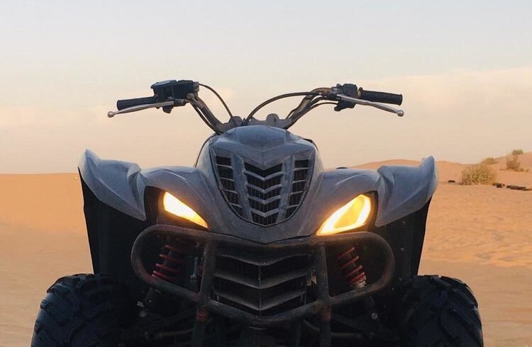 A quad bike parked in the desert in Dubai.