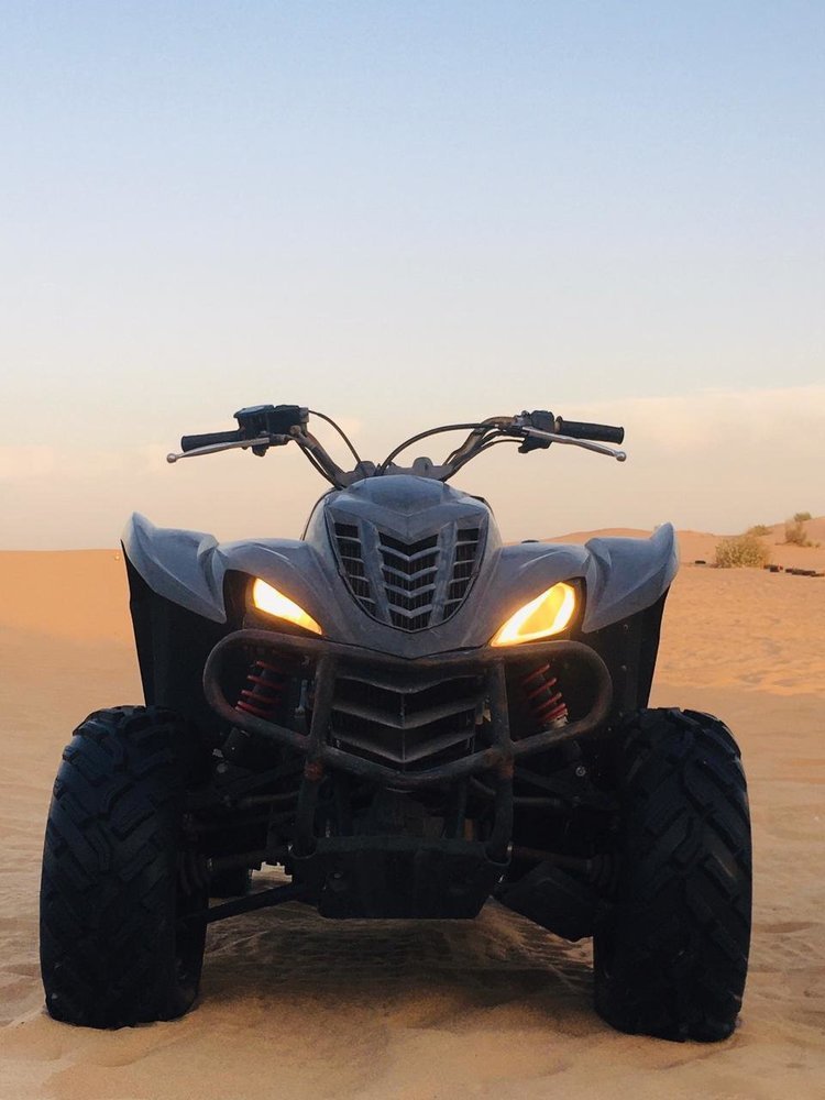 A quad bike parked in the desert in Dubai.