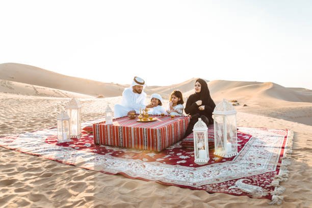 Happy family spending a wonderful day in the desert making a picnic