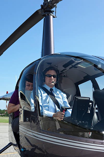 Passenger with pilot on a helicopter.