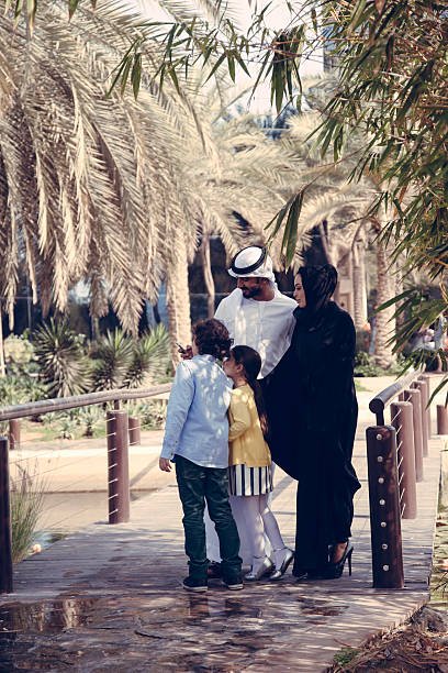 Middle Eastern Family Having Fun Using Smart Phone Outdoors