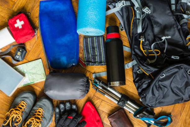 Equipment that would fit into a backpack to go out on a trail in the mountains.