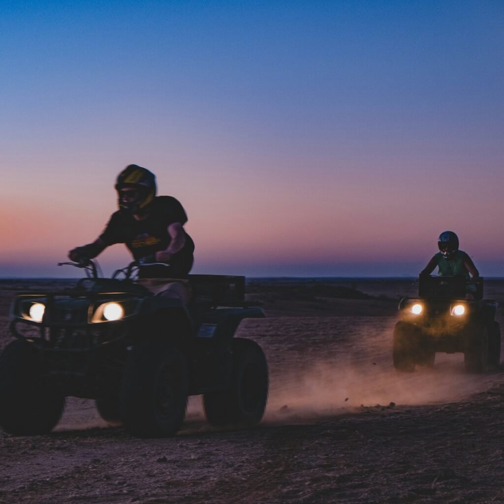 Two people Riding the Quadbikes at sunset