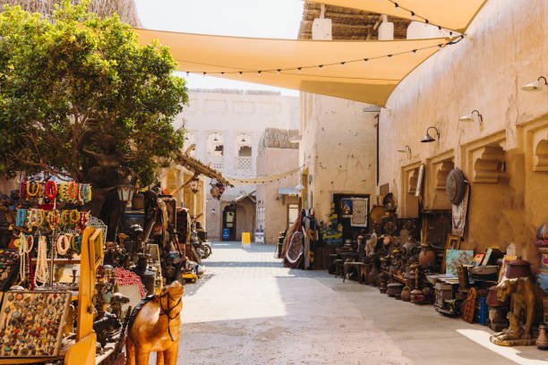 Flea market at the old streets with authentic Persian buildings at Bastakiya district of Dubai city by the bay, United Arab Emirates